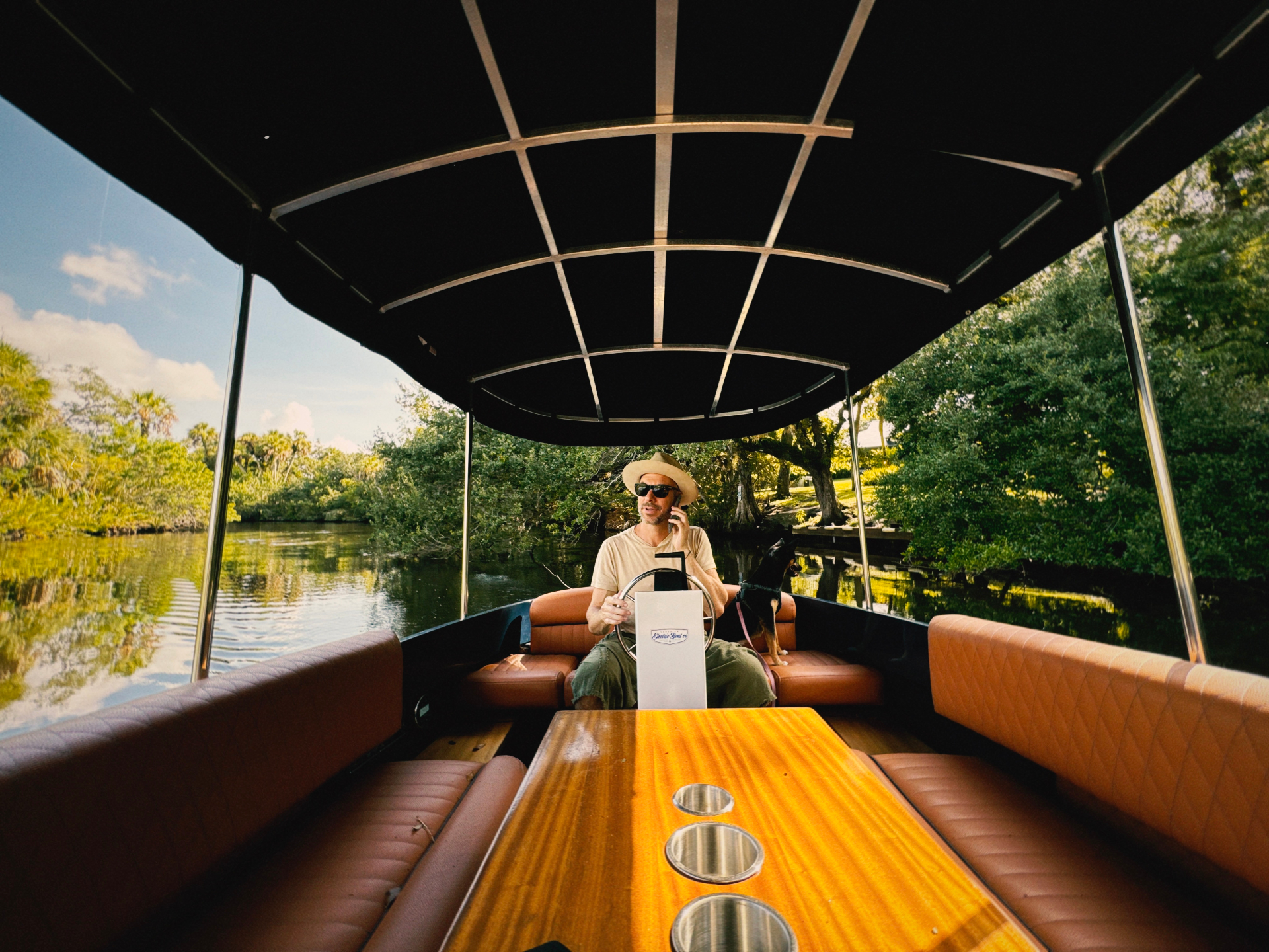 Tony Cho on an electric boat drifting through a mangrove waterway