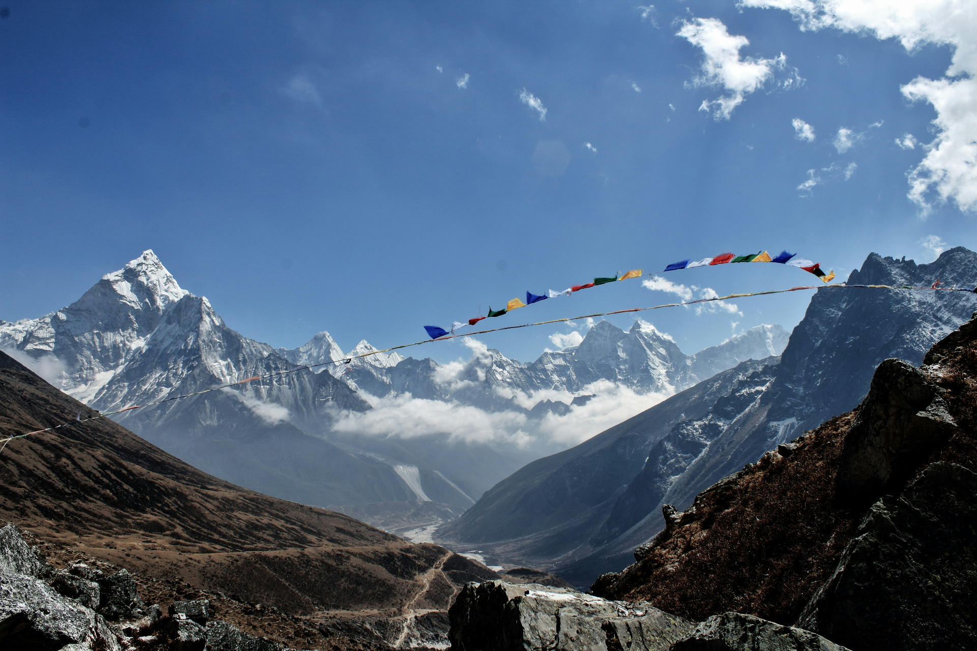 Prayer flags strung between Himalayan peaks
