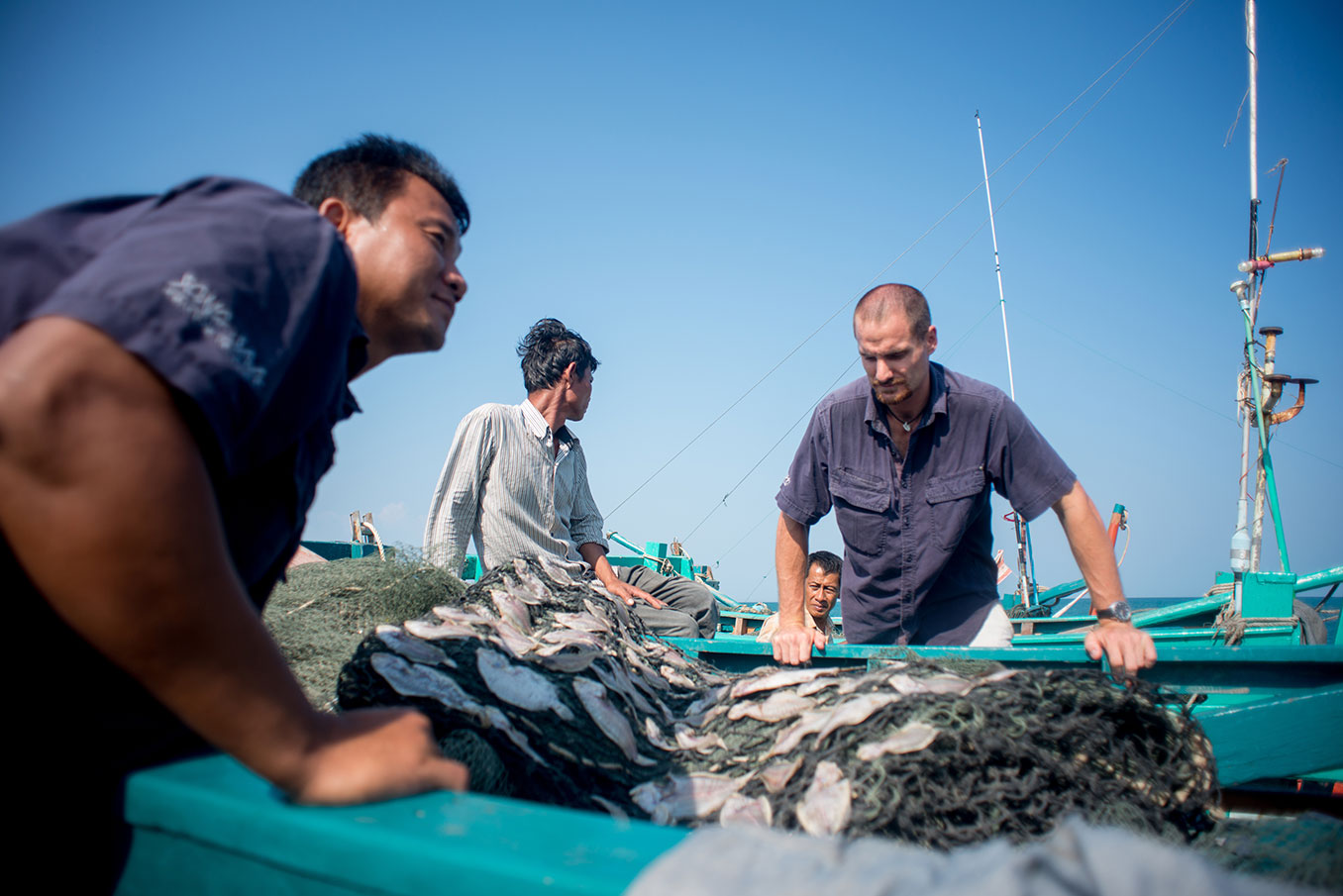 Fishermen sorting nets in the Koh Rong Archipelago