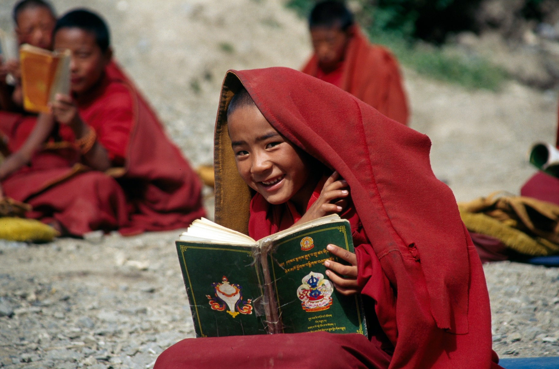 Young Tibetan monk reading scripture