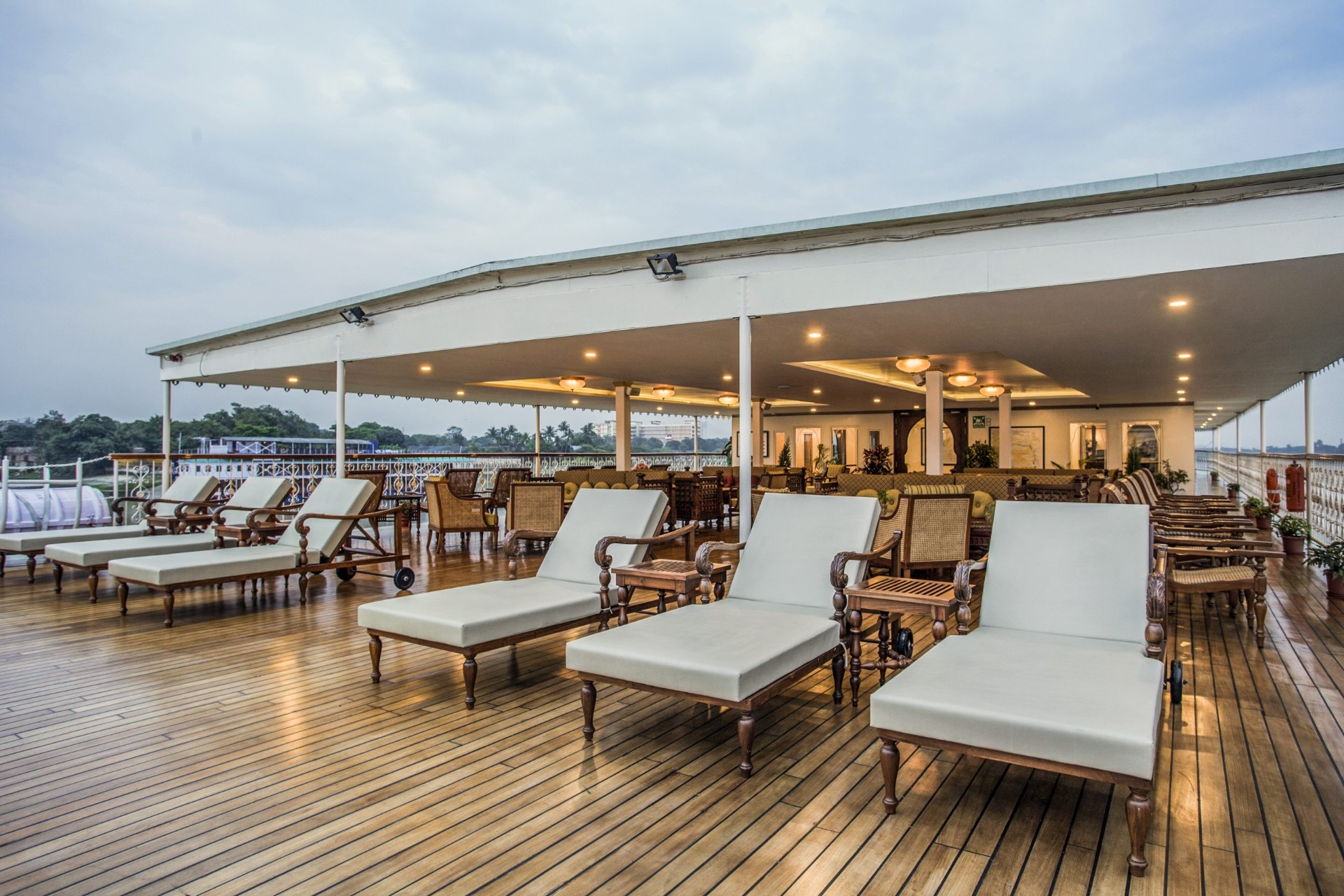 Sun deck with teak loungers and colonial-style seating aboard Antara's Ganges Voyager II