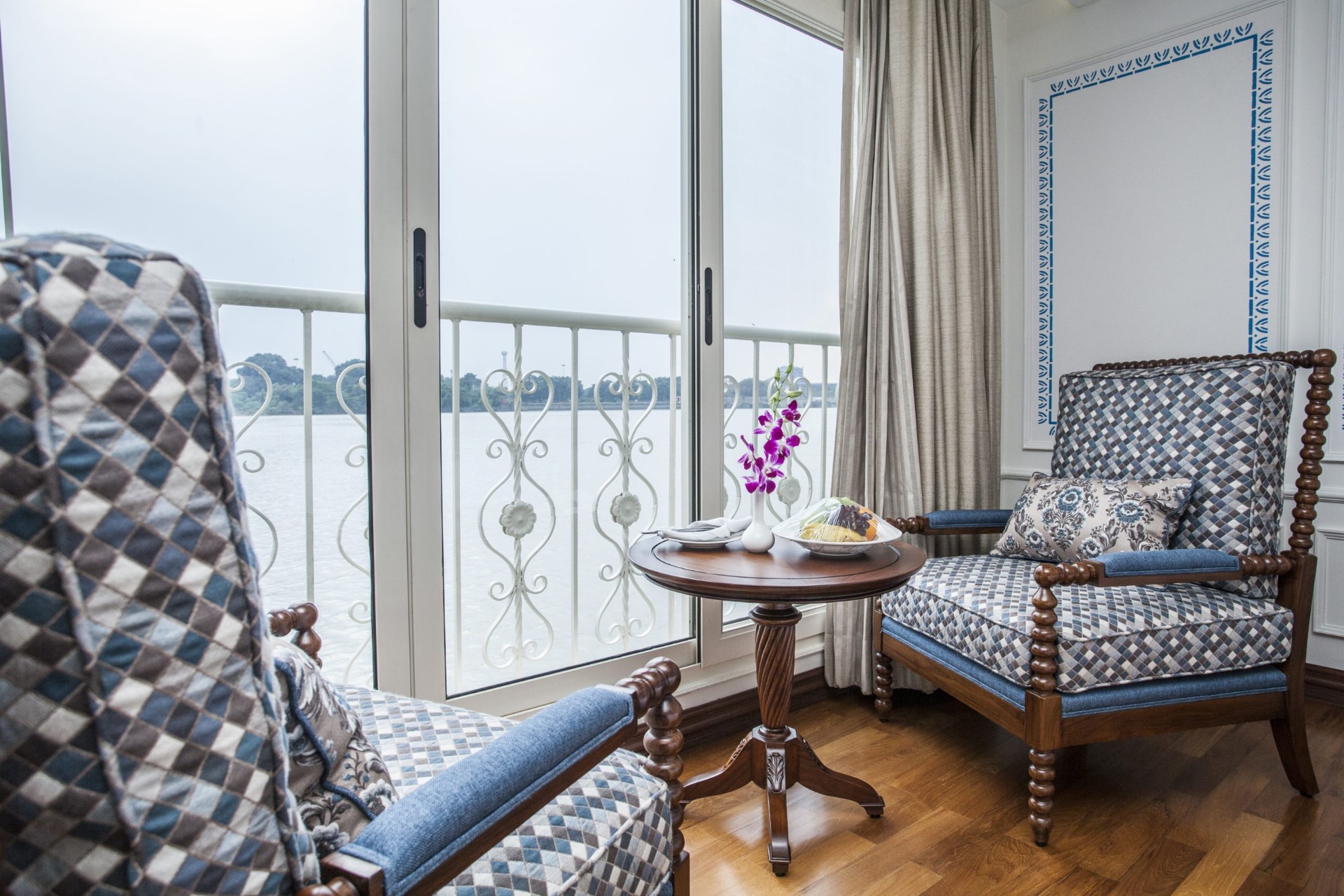 Suite sitting area with French balcony overlooking the Ganges River