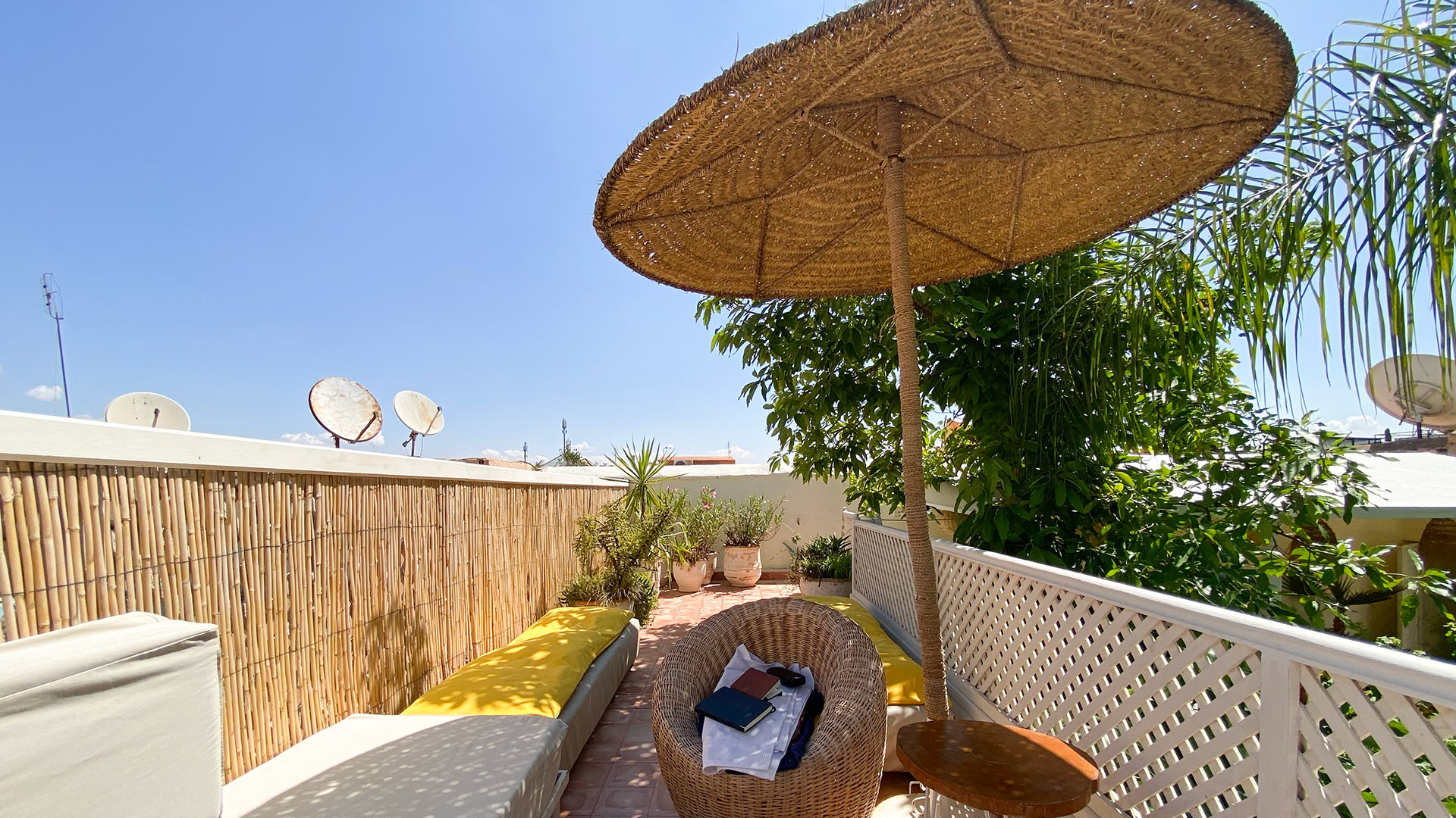 Rooftop lounge with wicker umbrella