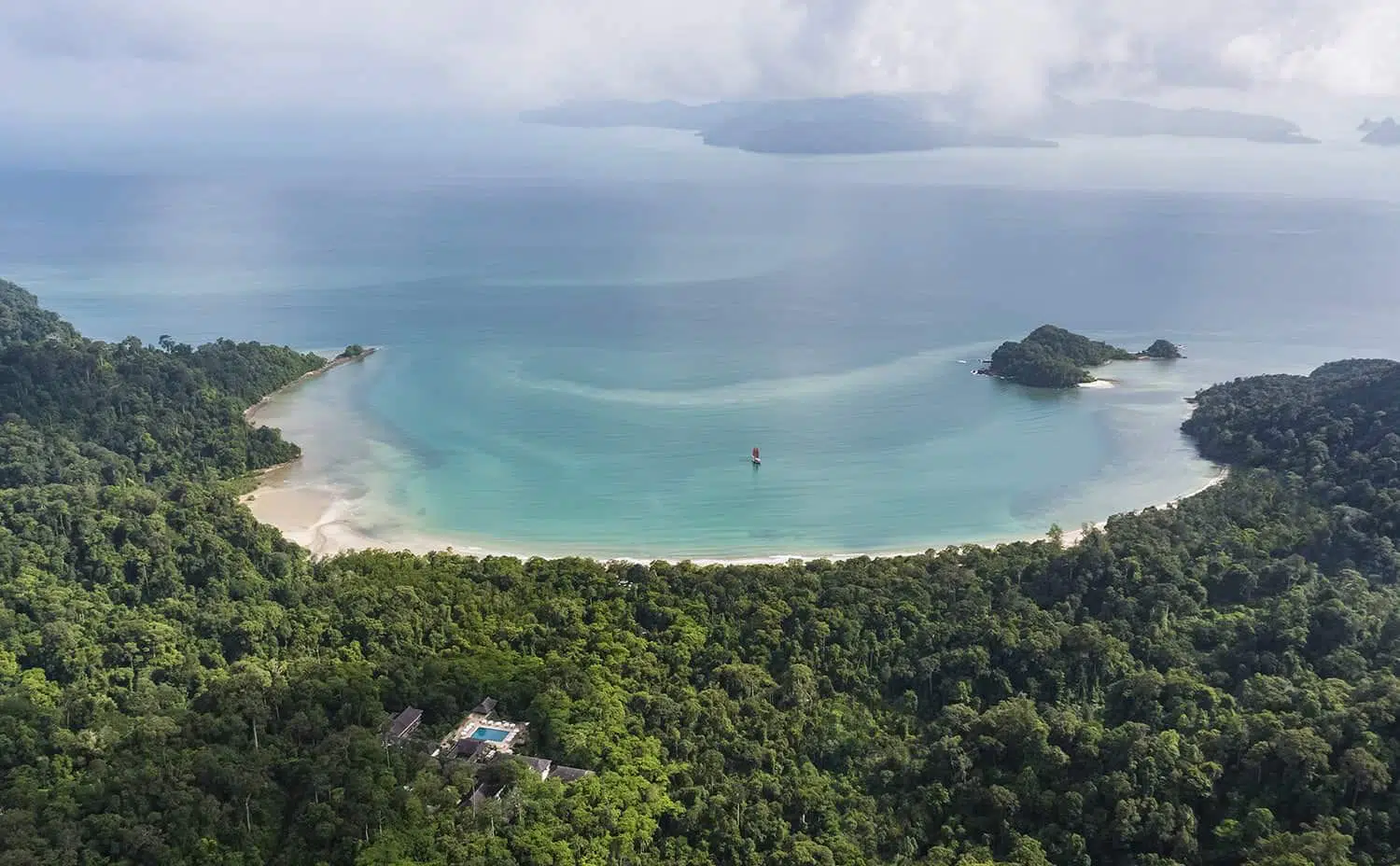Aerial view of Datai Bay's crescent beach and rainforest