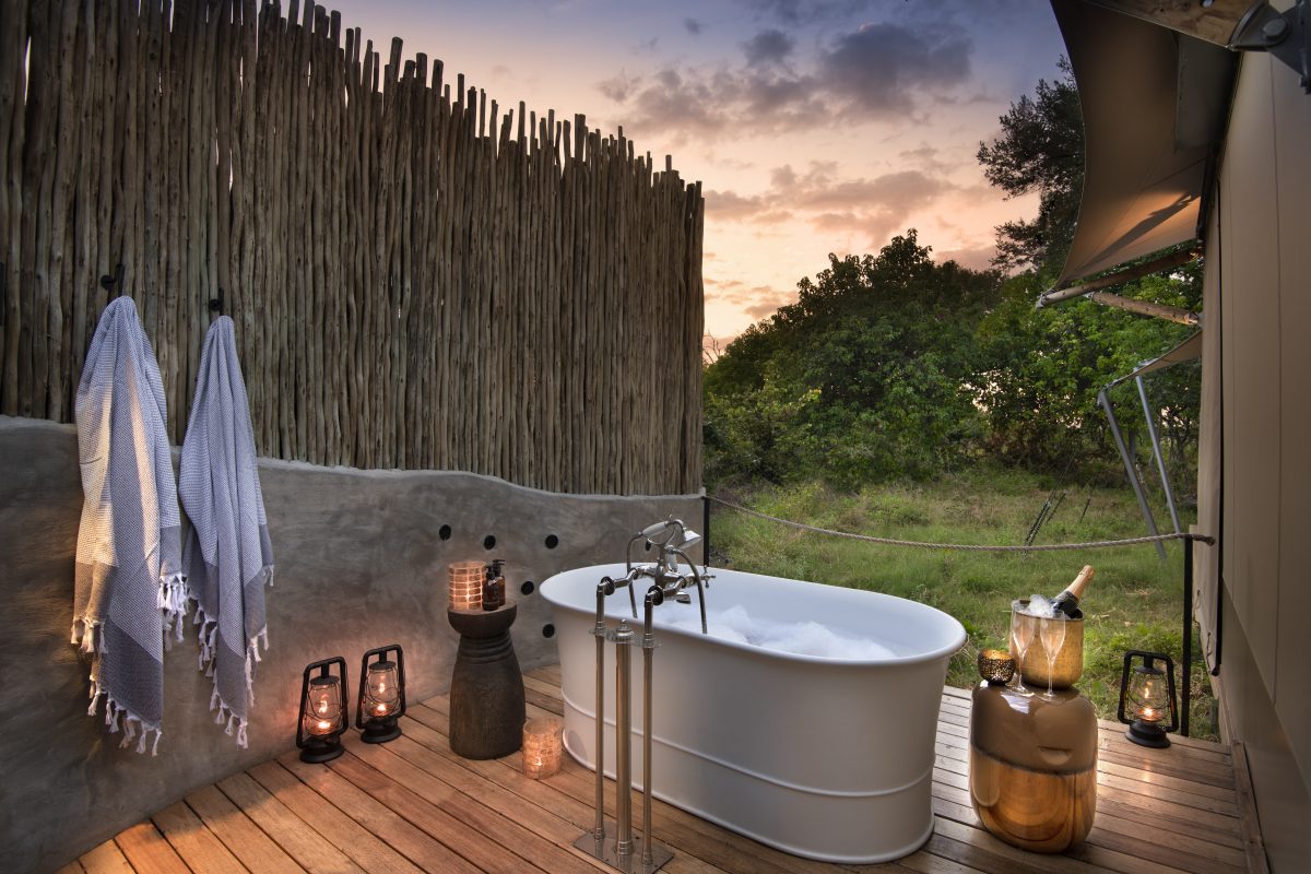 Outdoor bathtub under the African sky at sunset