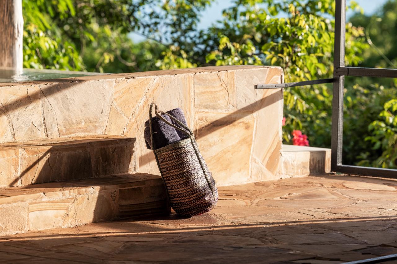 Handwoven basket with amenities on stone steps