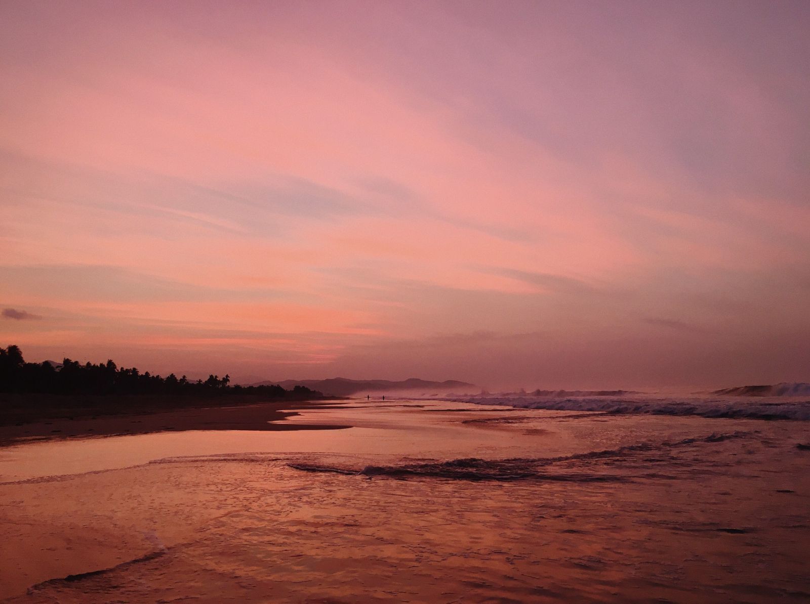 Pink and lavender sunset over the Pacific surf at Playa Viva's private beach