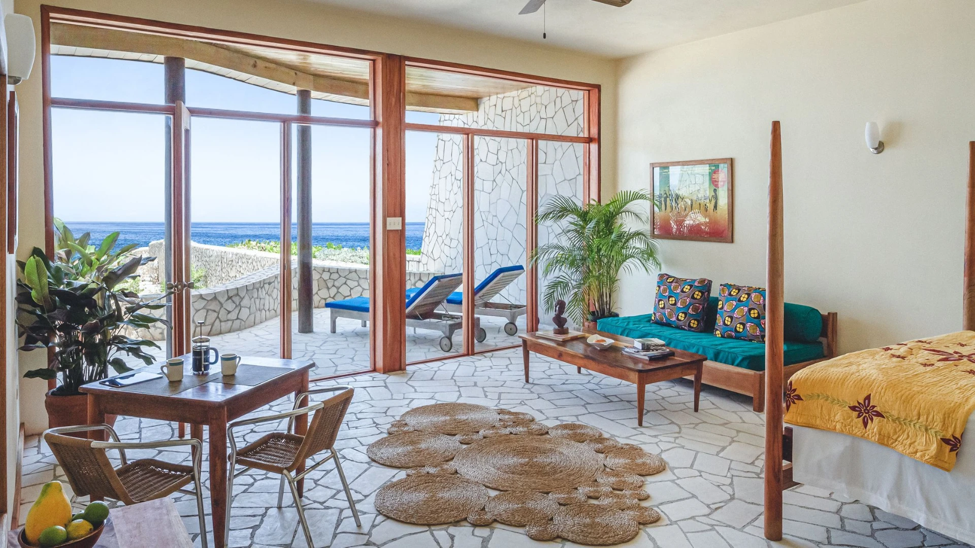 Sunlit Rockhouse villa living room with ocean-facing terrace