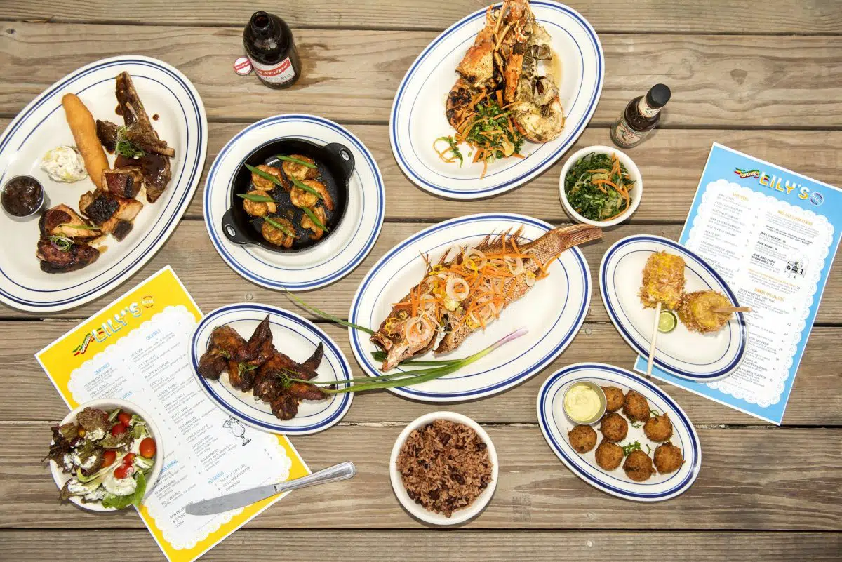Overhead spread of Jamaican dishes at Eily's restaurant on the beach