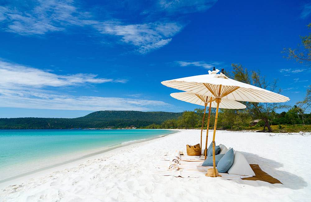 Beach picnic setup on pristine white sand