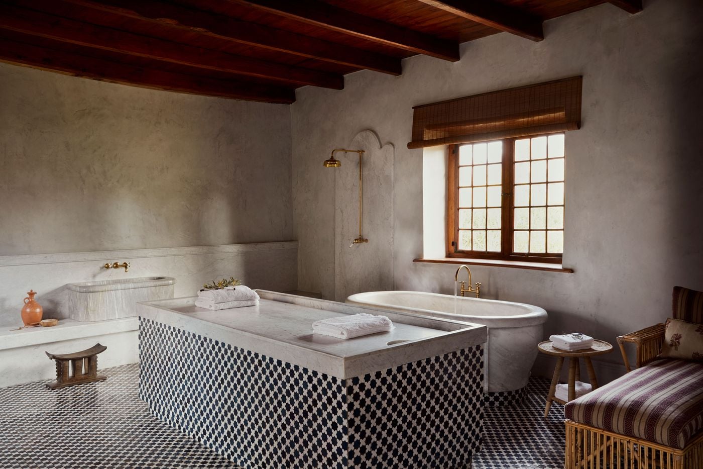 Hammam-style bathroom with checkered tile and brass fixtures