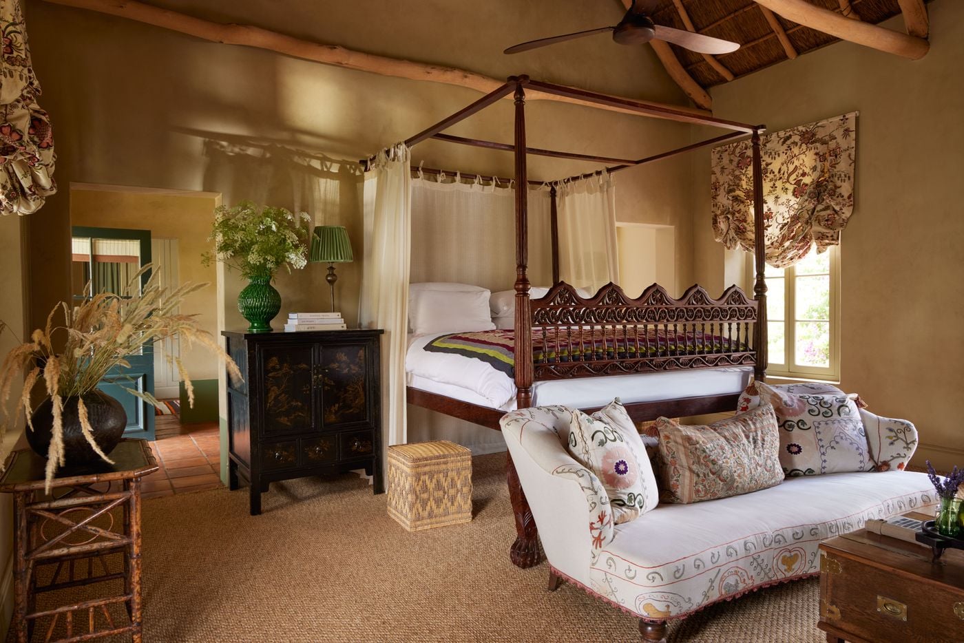 Four-poster canopy bedroom with antique furnishings