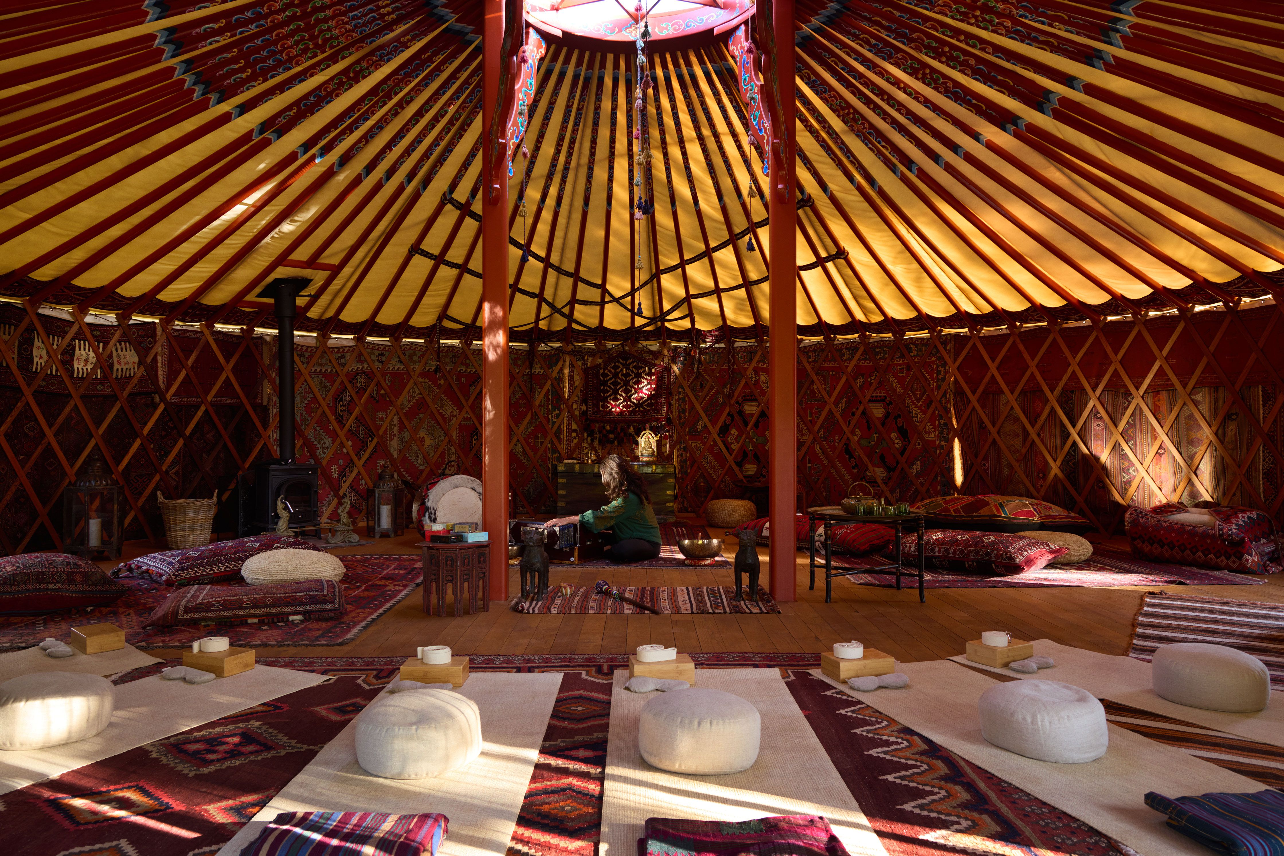 Meditation yurt with traditional rugs and cushions