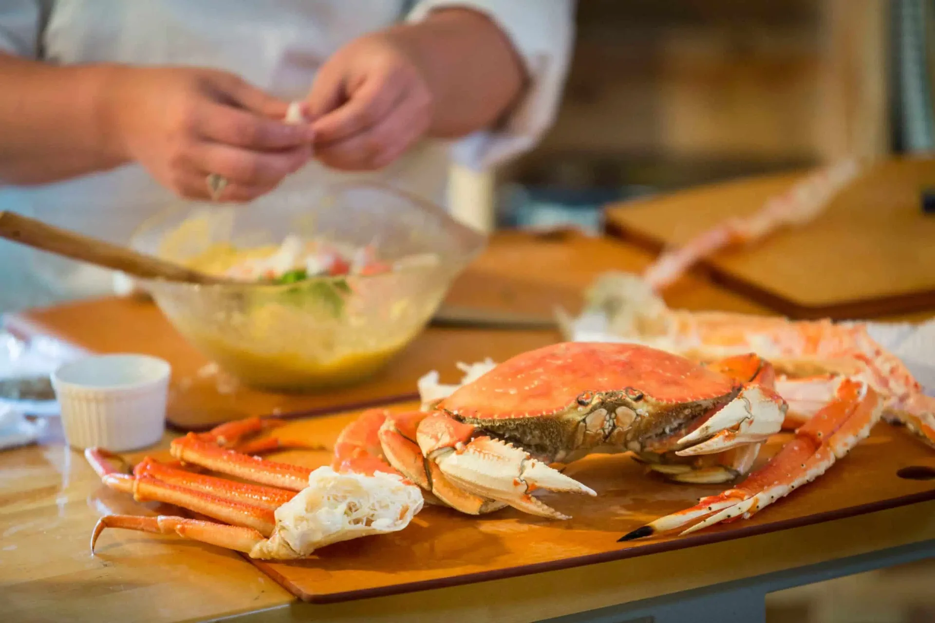 Chef preparing fresh-caught Alaskan crab in the Tutka Bay kitchen
